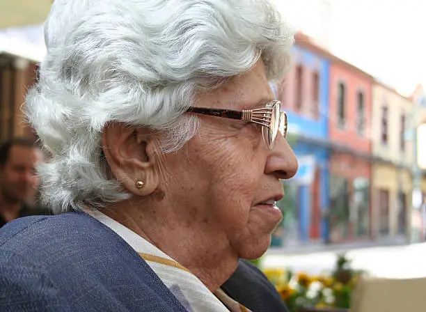 elderly female having a conversation at a cafe shop