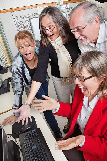 A Group of Surprised Mature Adults Looking at Computer.