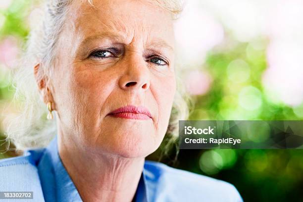 Elderly Woman Staring Seriously And Suspiciously Stock Photo - Download Image Now - Displeased, Headshot, Senior Women