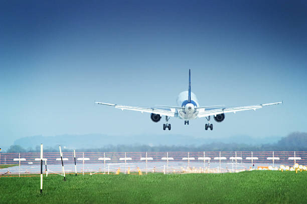 Touch Down Airplane right before touch down. View from behind. landing touching down stock pictures, royalty-free photos & images