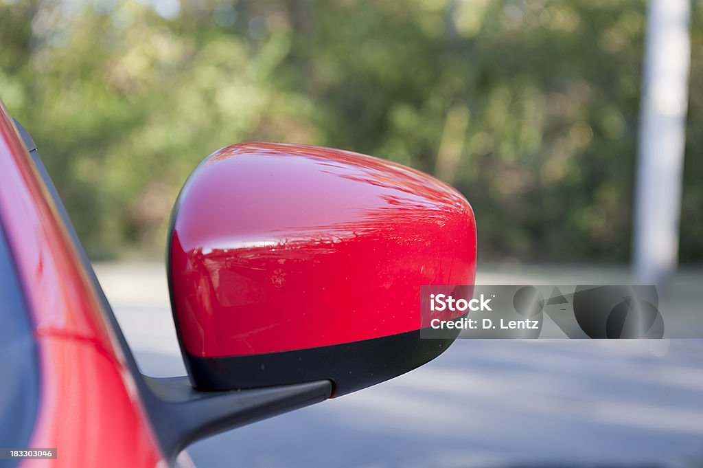 Car Side Mirror The side mirror on a red car. Red Stock Photo