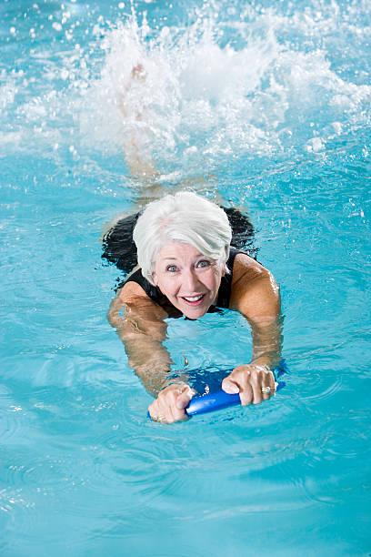 istock Active senior woman exercising in swimming pool 183303239