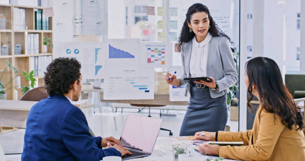istock Workshop, presentation and team with woman speaker, creative ideas in office with stats and training. Leadership, man and women at startup with charts, laptop and brainstorming together in meeting. 1833034706