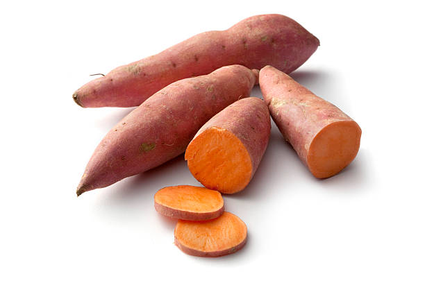 vegetables: sweet potato isolated on white background - zoete aardappel fotos stockfoto's en -beelden