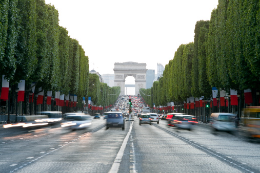 traffic on Avenue des Champs-Elysees decorated with flags before the Bastille Day - French National Holiday Click here to view more related images:
