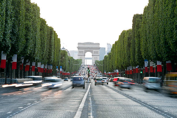 Avenue des Champs-Elysees and Arc de Triomphe, Paris, France traffic on Avenue des Champs-Elysees decorated with flags before the Bastille Day - French National Holiday Click here to view more related images: bastille day photos stock pictures, royalty-free photos & images