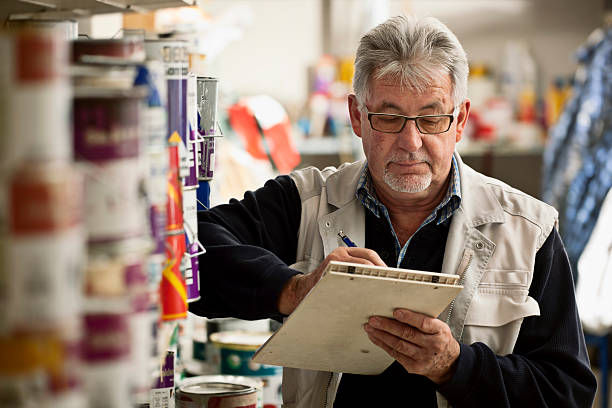 Senior Man Taking Inventory stock photo