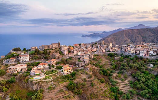 Aerial view of Forza D'Agro, Sicilian historical city on the rock  and the beautiful sicilian coasts. Taormina, Sicily, Italy.