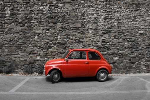 Tiny red vintage car in Florence, Italy