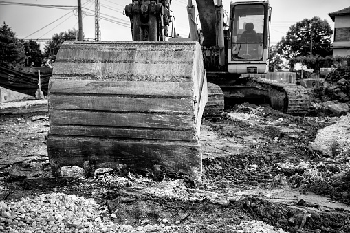 Industrial background. Digger bucket close-up. Construction excavator bucket.