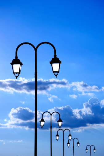 Several lampposts and clouds.