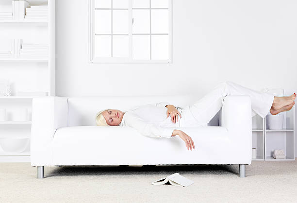 istock Blond woman fell asleep on the couch reading a book 183304627