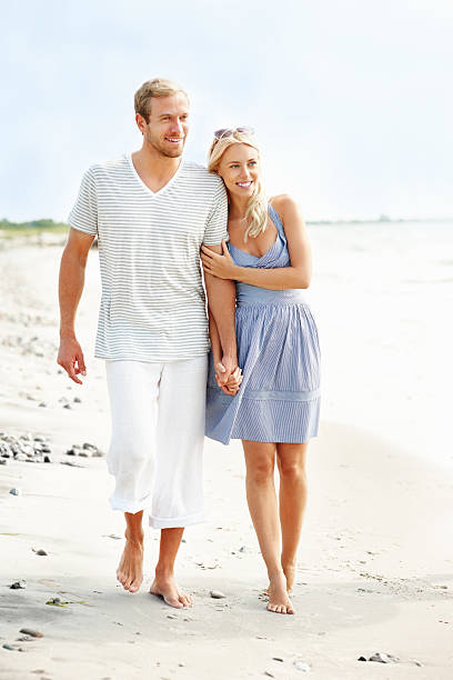 istock Loving, young couple walking on the beach, holding hands 183304634