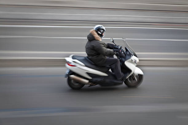 istock Man on motorbike riding fast blurred background panned 183304796
