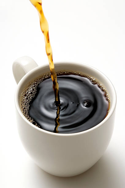 Isolated shot of pouring a fresh coffee on white background