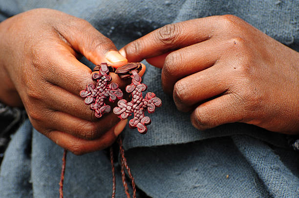 Boy holding leather crosses in Lalibela, Ethiopia Hands of a boy holding two leather crosses in Lalibela, Ethiopia ethiopian orthodox church stock pictures, royalty-free photos & images