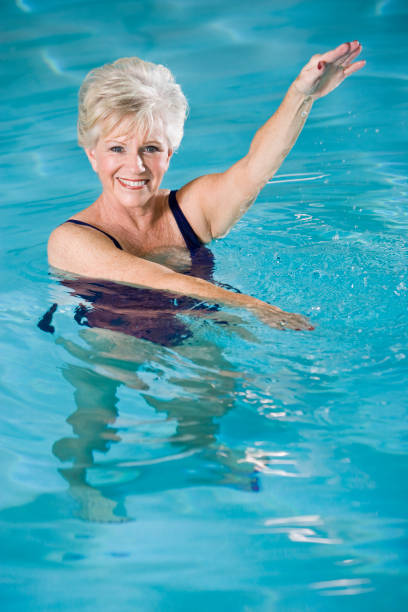 istock Active senior woman exercising in swimming pool 183305295