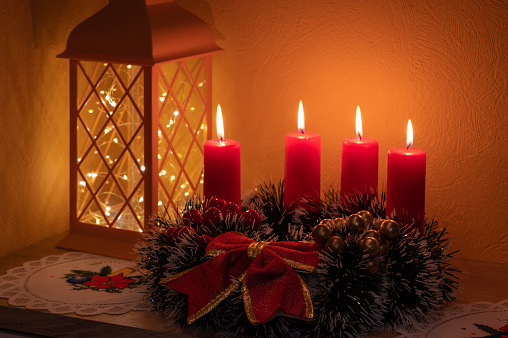 Three red candles on gray background, Christmas decoration. Advent mood.