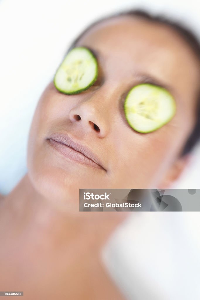 Mid adulto feminino com fatias de pepino para olhos - Foto de stock de Adulto royalty-free