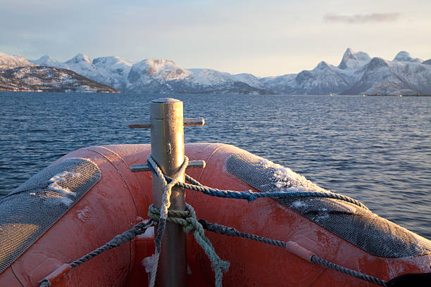 Cruising a Norvegian fjord with an inflatable raft on a cold winter day.