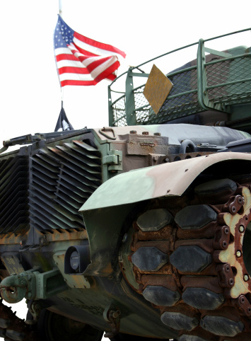 3D rendering of a people carrier army truck on caterpillar tracks in empty studio background.