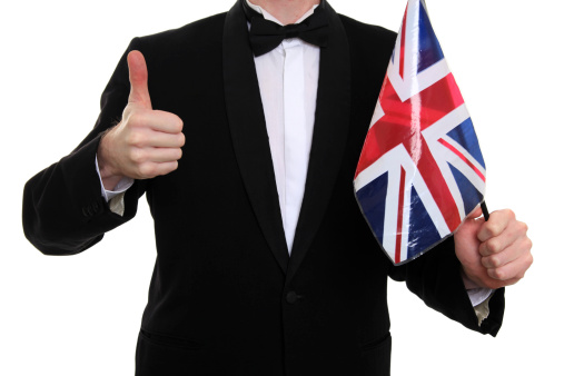 Male in tuxedo with Union Jack flag with thumbs up