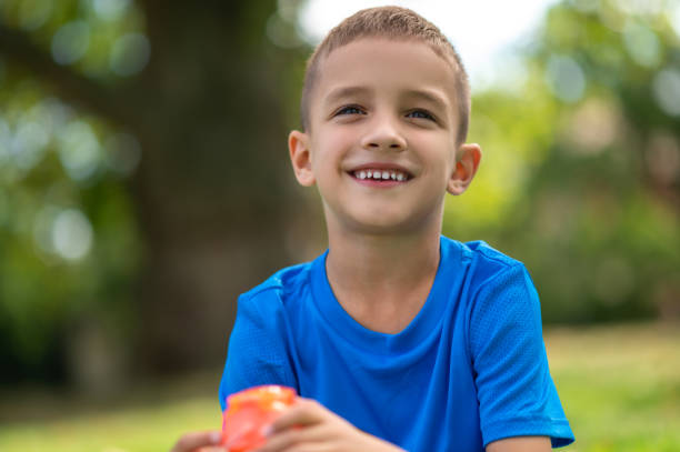 istock Cute boy of school age in blue tshirt looking contented 1833065390