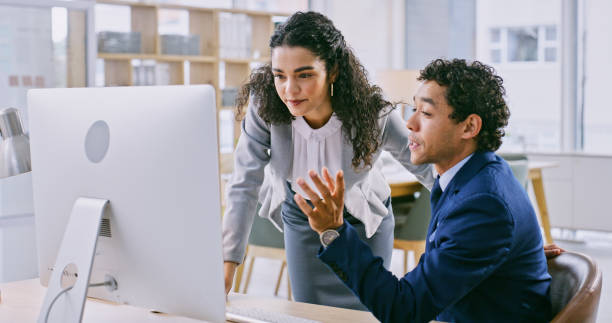 istock Office, computer and business people with conversation, help and advice with teamwork, corporate training and professional. Staff, manager and employee with a pc, cooperation and collaboration 1833071692