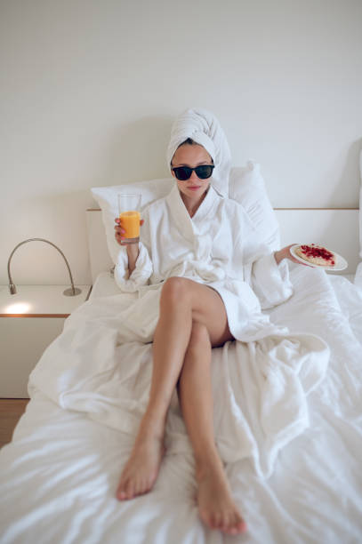 istock Pretty young woman having healthy breakfast and looking contented 1833088981