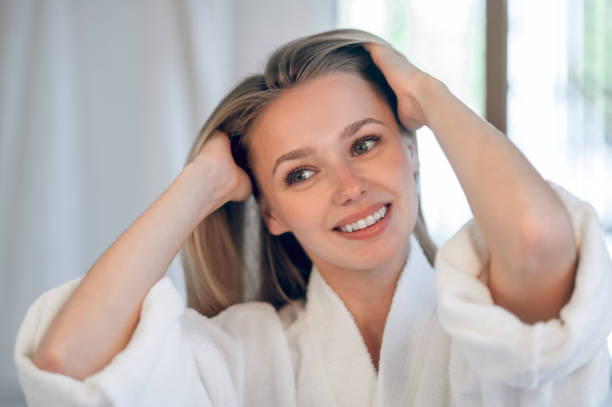 istock Blonde young woman making hair 1833089518