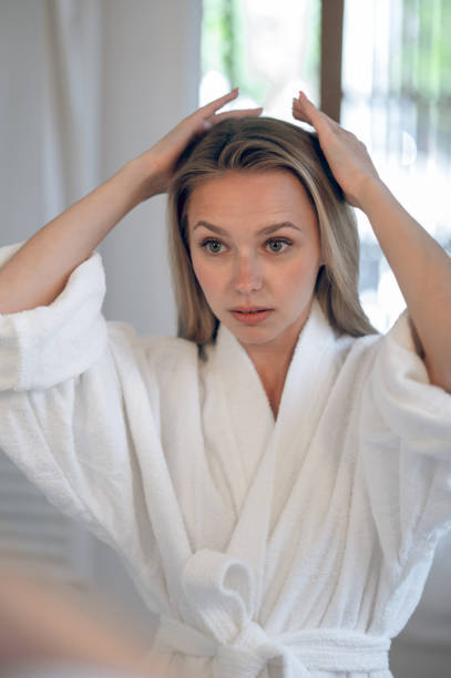 istock Blonde young woman making hair 1833089519