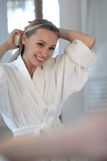 istock Blonde young woman making hair 1833089537