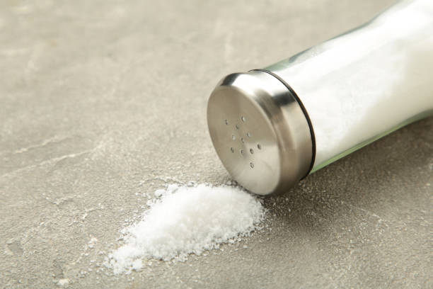 istock Glass salt shaker on gray background. Space for text 1833107298