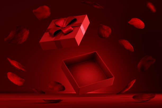 istock Open gift box flying with rose petals on red background. 1833110092