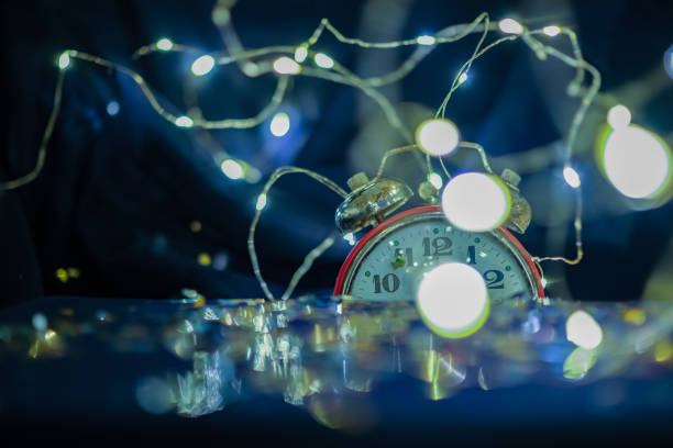 istock The blurred vintage alarm clock shows midnight. 1833117760