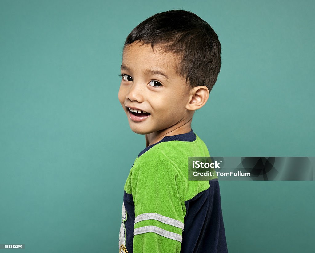 Little Boy Smiling boy (Filipino) in pajamas against blue background. 2-3 Years Stock Photo