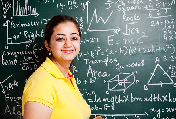 istock Attractive Young Indian Mathematics Teacher in a Classroom with Greenboard 183312545
