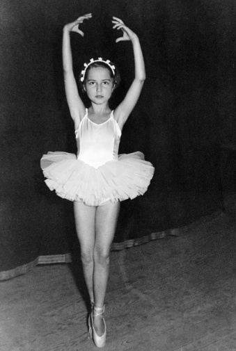 Girl dancing in 1959.Some scratches due to the age of the photo. Scanned print.