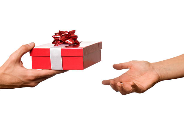 istock Hand outstretched to receive red and white wrapped gift 183312658
