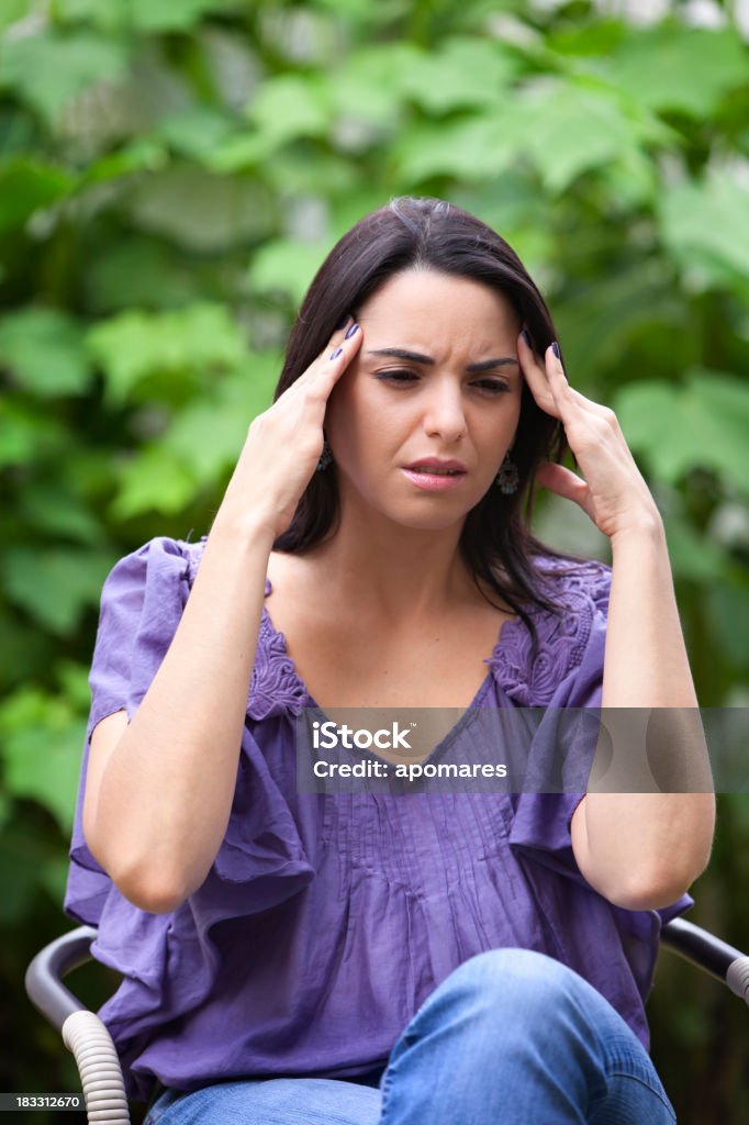 Young woman with a headache Young woman with a headache. Slightly motion blur. 20-24 Years Stock Photo