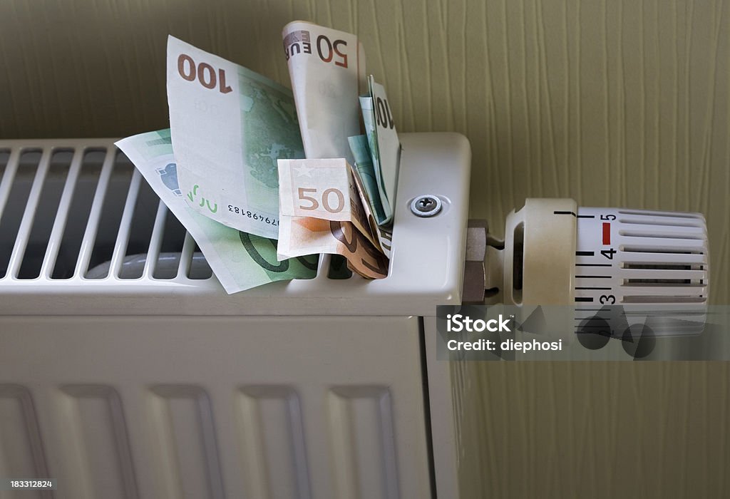 expensive to heat Euro banknotes stuck in a radiator Radiator - Heater Stock Photo