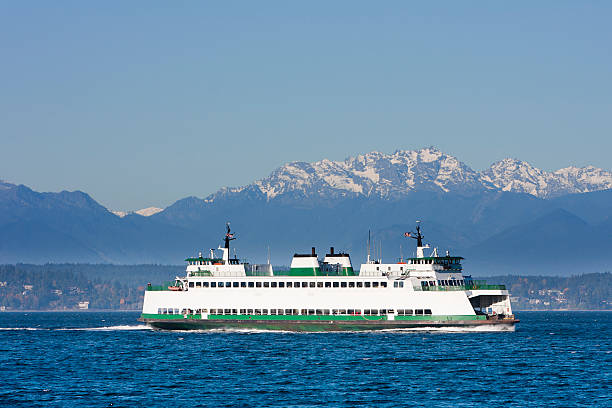 Washington State car and passenger ferry crossing Puget Sound. Olympic mountains in the background.