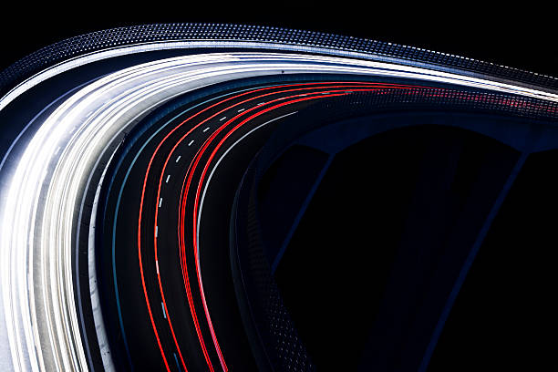 Trails for a traffic light on a black background traffic light trails, highway viaduct at night from a high angle view, blurred motion tail light stock pictures, royalty-free photos & images