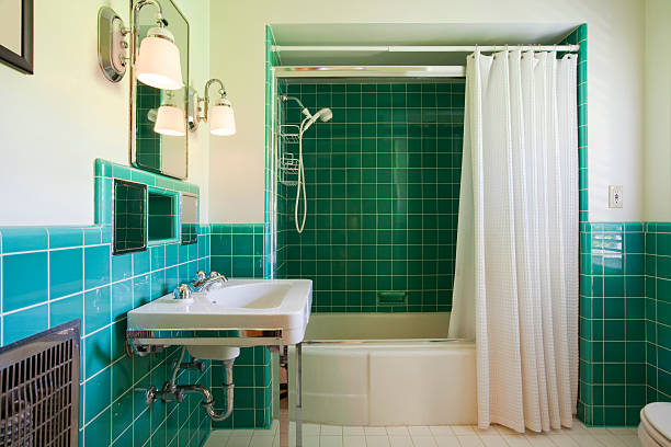 istock Green tiled bathroom with white suite and shower curtain 183313248