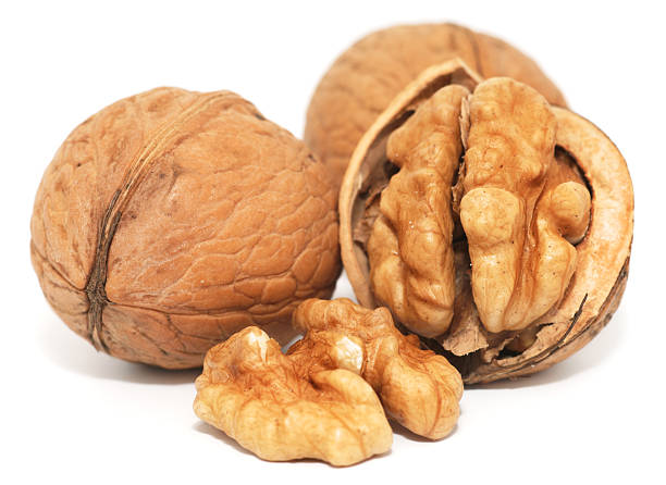 istock Close up photograph of three walnuts, one cracked open 183313623