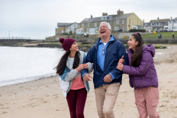 istock Walk Along The Beach with Their Grandad 1833136400