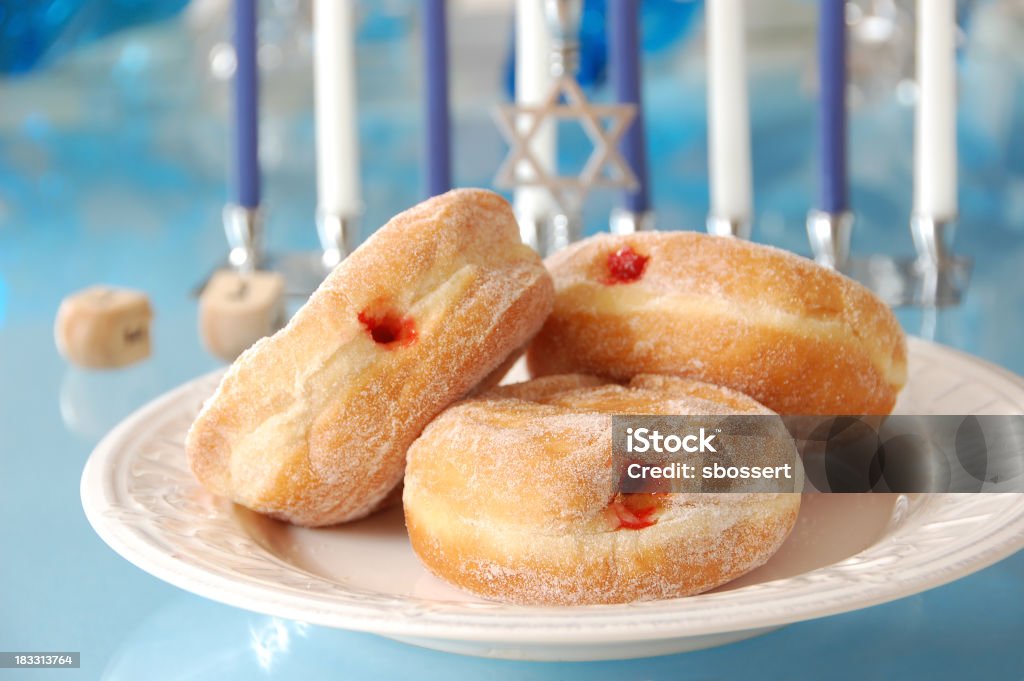 Sufganiyot for Hanukkah "Sufganiyot, deep-fried donuts filled with jelly, with other symbols of Hanukkah in the background.More Hannukah images:" Hanukkah Stock Photo