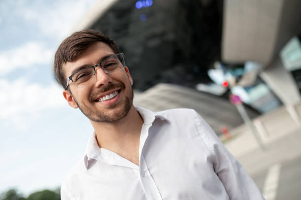 istock Young dark-haired man in white shirt smiling a d feeling joyful 1833141161