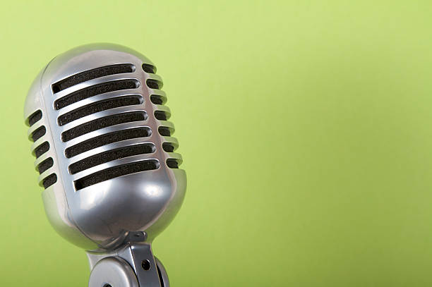 istock Close-up of a microphone on a green background 183314157