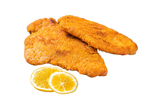 Roasted breaded german weiner schnitzel on a plate. Isolated, white background